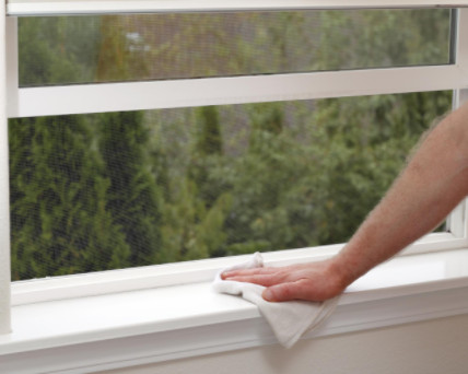 person dusting windowsill: Gagne Heating and Air Conditioning Residential Heating & Air Blog