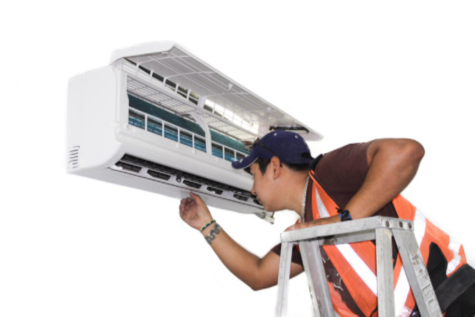 man installing a ductless mini split air conditioner