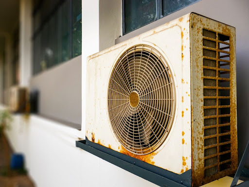 Old outdoor AC unit shows signs of rust.